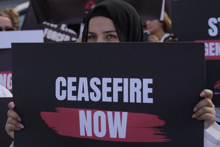 A member of the international humanitarian group 'Doctors Without Borders' holds a placard during a protest, calling for an end of the war in Gaza and for an immediate cease-fire, at Martyrs' Square in downtown Beirut, Lebanon, Monday, Sept. 15, 2025. (AP Photo/Hussein Malla)