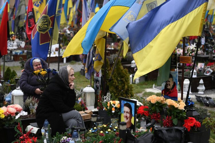 Smutnící ženy u hrobů ukrajinských vojáků na Lyčakovském hřbitově ve Lvově během Dne ozbrojených sil Ukrajiny. FOTO: Profimedia